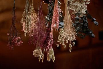 Bunch of flowers drying on rope