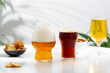 A few glasses with light and dark beer and foam