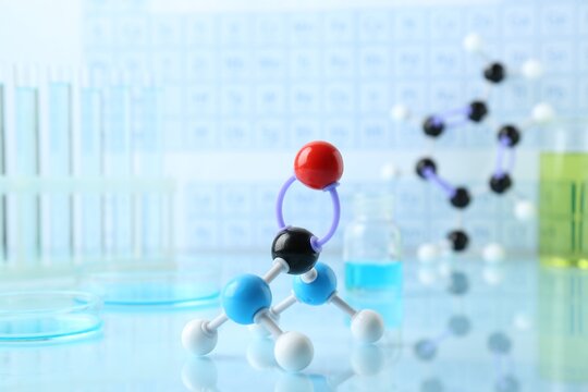 Molecular model on light surface against blurred background - Powered by Adobe