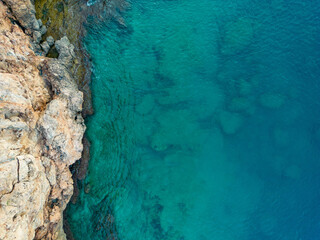 Fototapeta na wymiar Aerial bird's eye view of cliffs and turquoise sea in Antalya Turkey