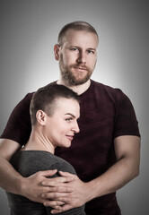 Portrait of attractive cute cheerful couple cuddling,