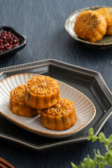 Delicious Cantonese moon cake for Mid-Autumn Festival food mooncake on blue table background.