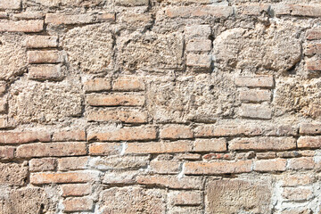 Old ancient bricks on the wall of the house as an abstract background. Texture