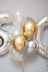 silver balloons number 50 and a bunch of latex balloons with helium