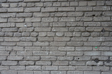 Background - old and scratched grey brick wall