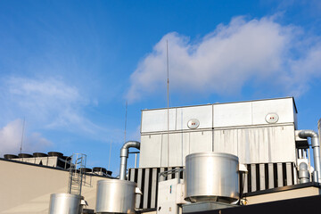 Obraz premium Central unit of the ventilation and air conditioning system on the roof of the building. The photo was taken in natural, soft light. View from above.