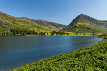 A beautiful, calm lake surrounded by high mountains in summer (Buttermere, Lake District)
