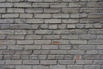 Texture of old and scratched grey brick wall