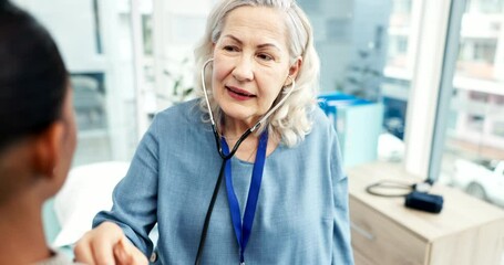 Doctor, woman and listening with stethoscope to patient heartbeat, healthcare consultation and cardiology test in clinic. Senior medical worker check chest, lungs and breathing assessment in hospital