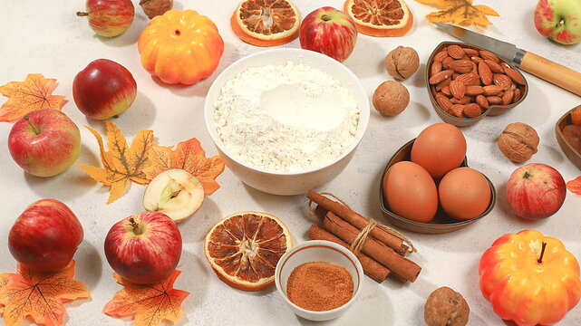 Kitchen background with pumpkin, apples, spices, nuts, flour, eggs, food preparation concept, ingredients for pumpkin and apple pies recipe, menu for restaurant, selective focus, top view,