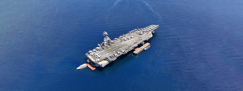 Aerial drone ultra wide panoramic photo with copy space of latest technology nuclear powered aircraft carrier USS Gerald R. Ford anchored in deep blue open ocean sea