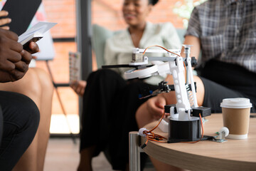 Group of diverse business people working together in the office, Brainstorming about the hand robot model to be used for production work