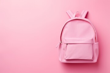 Backpack with school supplies top view on pink empty background