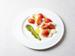 Cherry tomato salad with cheese on a plate