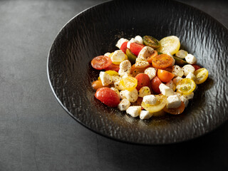 Vegetable salad with cheese and cherry tomatoes on a plate
