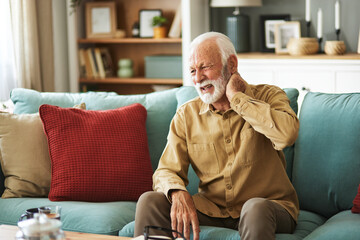Senior man feeling exhausted and suffering from neck pain
