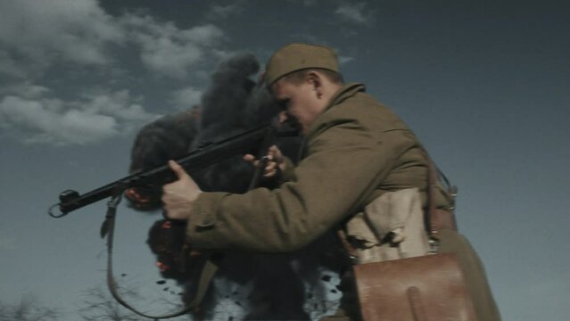 Time-stopping mfps shot of soviet troop attacking nazi soldiers during battle on autumn day, Second World War reenactment
