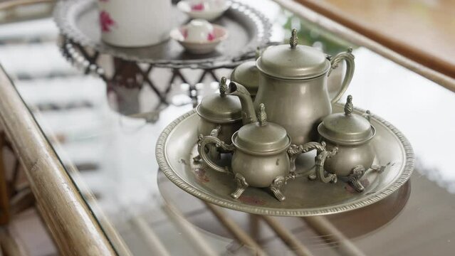 a metal vintage tea set. The metallic sheen and intricate details encapsulate a bygone era, inviting you to experience the charm of yesteryears with every sip. High quality 4k footage