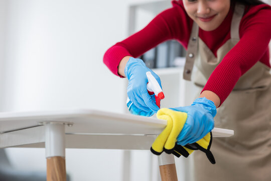 female cleaning staff Woman cleaning computer table at home professional cleaning service