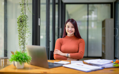 Businesswoman working attentively in front of laptop.Document review, analysis, and planning
