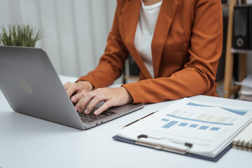 Close up hands of woman in brown formal suit checking bills, taxes, bank account balance, using calculator, Personal Checking, Empower Checking, Personal Savings, Certificates, IRAs, Money Market