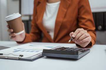 Close up hands of woman in brown formal suit checking bills, taxes, bank account balance, using calculator, Personal Checking, Empower Checking, Personal Savings, Certificates, IRAs, Money Market