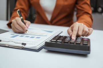 Close up hands of woman in brown formal suit checking bills, taxes, bank account balance, using calculator, Personal Checking, Empower Checking, Personal Savings, Certificates, IRAs, Money Market