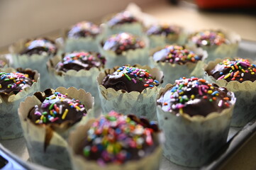 Chocolate cupcakes with small colorful candies, home baking