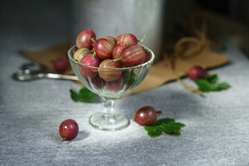 Ripe red gooseberries in a vintage vase. Vintage rustic rustic concept
