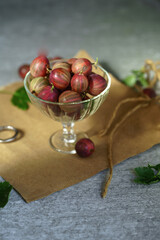 Ripe red gooseberries in a vintage vase. Vintage rustic rustic concept