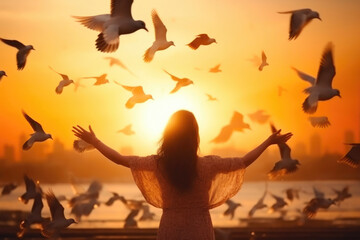 Sunset Serenity: Woman Releasing Birds