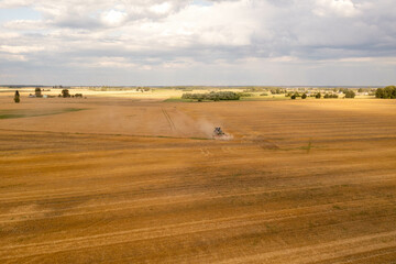 Fototapeta na wymiar Drone photography of a farmer cultivating land with a tractor