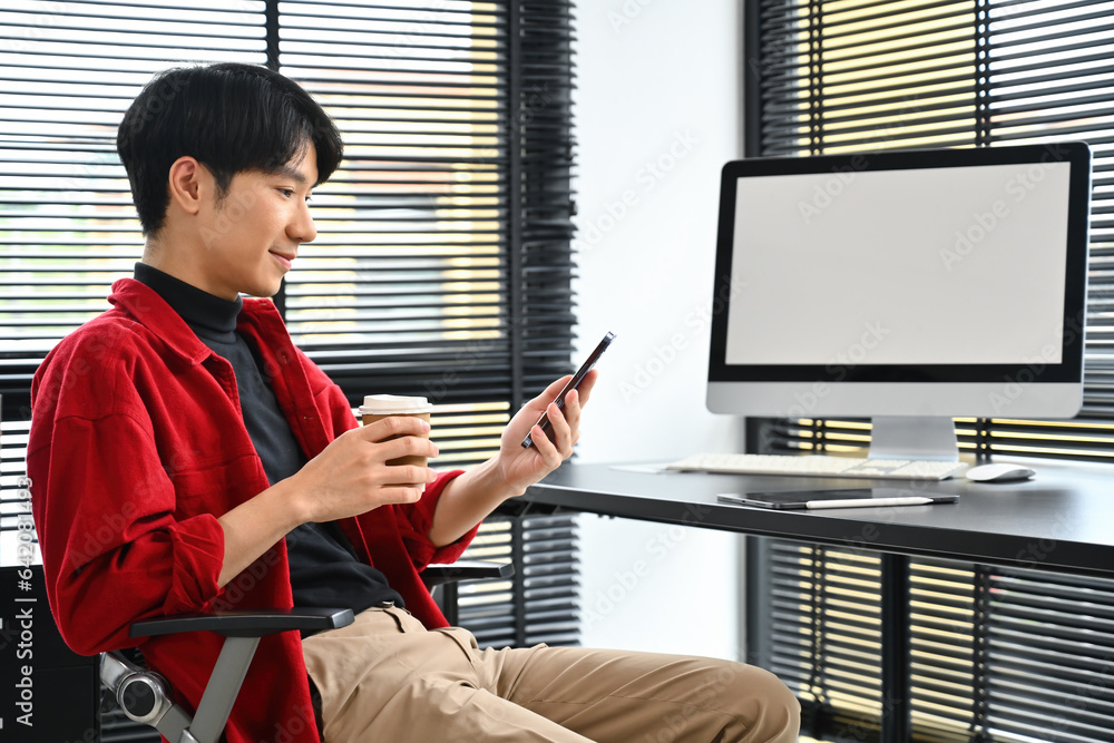 Aufkleber side view image of young creative designer man or programer using smartphone while sitting in the wo
