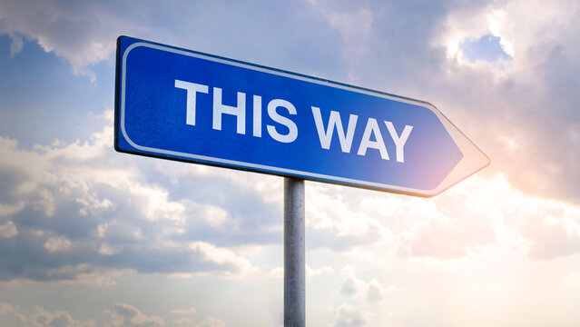 Naklejki Street directional sign with the word "This Way”, signpost guiding in a specific direction, wayfinding concept