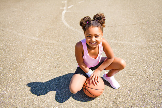 Girl With Basketball On Court On Summer Season