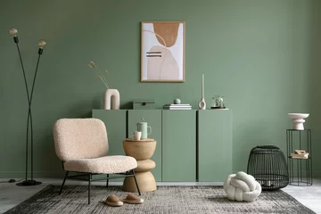 Fotobehang Per kamer Stylish living room interior design with mock up poster frame, frotte armchair, wooden commode, side table, plants and creative home accessories. Sage green wall. Home staging. Template. Copy space.  © FollowTheFlow