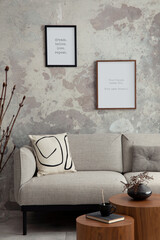 The stylish compostion at living room interior with design gray sofa, coffee table, posters and...