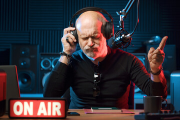 Radio host listening to music