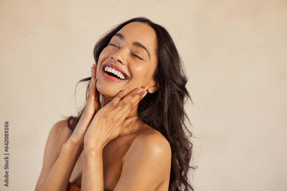 Wall mural beautiful laughing woman touching her skin with joy