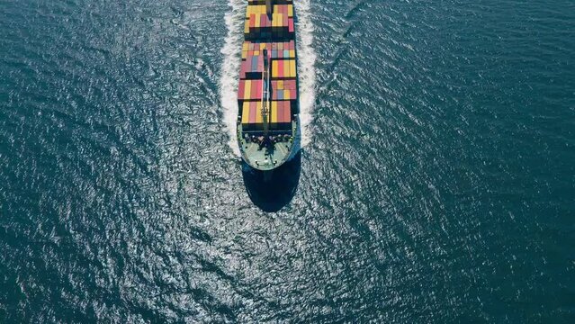 Container ship cruising open ocean sea for logistics import export, shipping or transportation, Aerial wide view