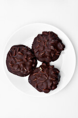 Chocolate chip cookies with nuts. Sweet appetizer on a white plate.