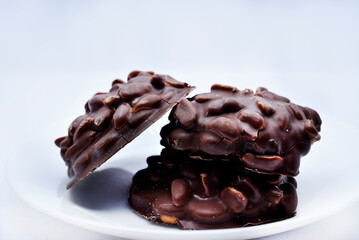 Chocolate chip cookies with nuts. Sweet appetizer on a white plate.
