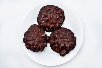 Chocolate chip cookies with nuts. Sweet appetizer on a white plate.