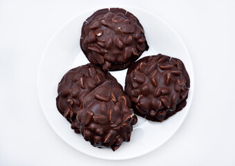 Chocolate chip cookies with nuts. Sweet appetizer on a white plate.