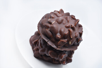 Chocolate chip cookies with nuts. Sweet appetizer on a white plate.
