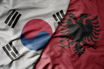 big waving national colorful flag of south korea and national flag of albania .