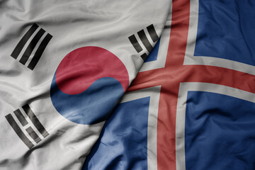Fototapeta premium big waving national colorful flag of south korea and national flag of iceland .