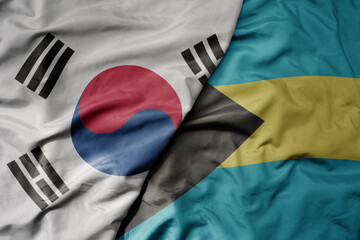 big waving national colorful flag of south korea and national flag of bahamas .