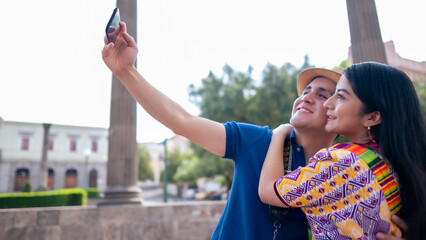 Beautiful lovers take a selfie and smile during the shot.