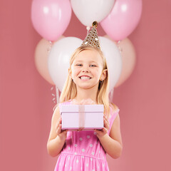 Present, birthday and portrait of a child with balloons in studio for party, holiday or happy...